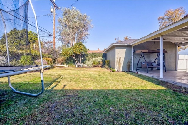 view of yard with a patio area and a trampoline