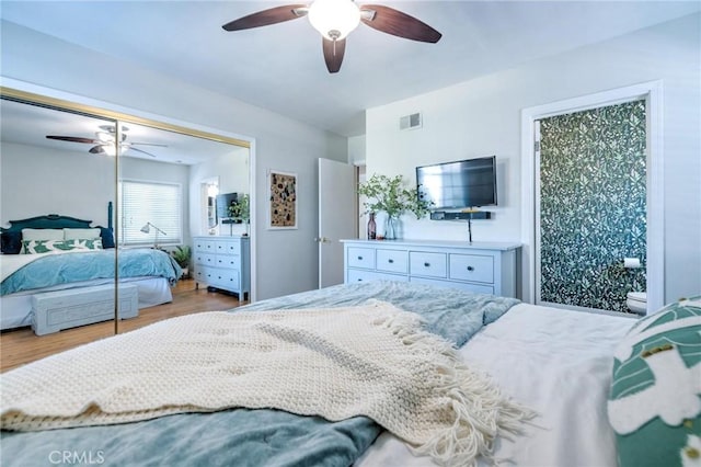 bedroom featuring light wood-type flooring, a closet, and ceiling fan