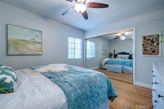 bedroom featuring light wood-type flooring, a closet, and ceiling fan