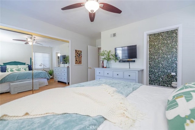 bedroom with ceiling fan, light wood-type flooring, and a closet