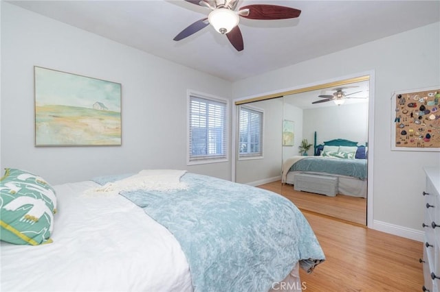 bedroom with light hardwood / wood-style floors, a closet, and ceiling fan