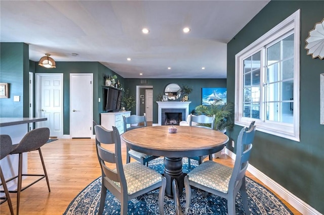 dining space with light hardwood / wood-style floors