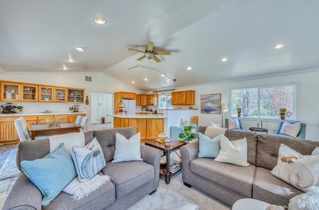 living room featuring lofted ceiling, ceiling fan, and crown molding