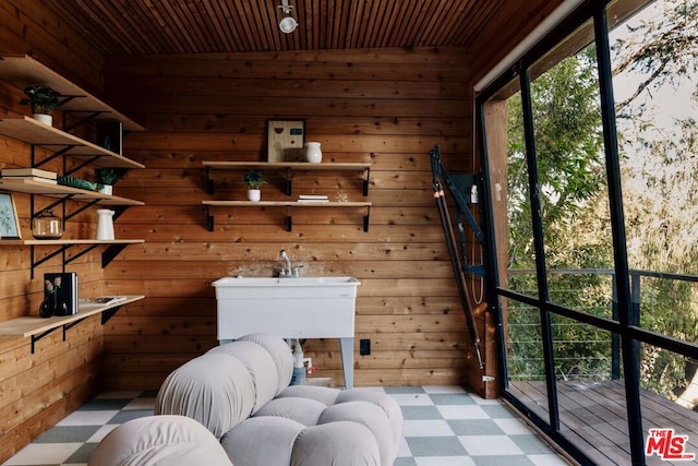 laundry area with wood ceiling and wooden walls