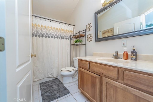 bathroom featuring toilet, vanity, and tile patterned floors