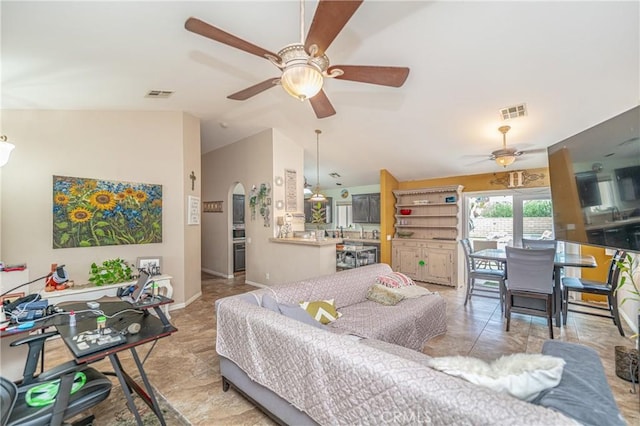 interior space featuring vaulted ceiling, ceiling fan, and light tile patterned flooring