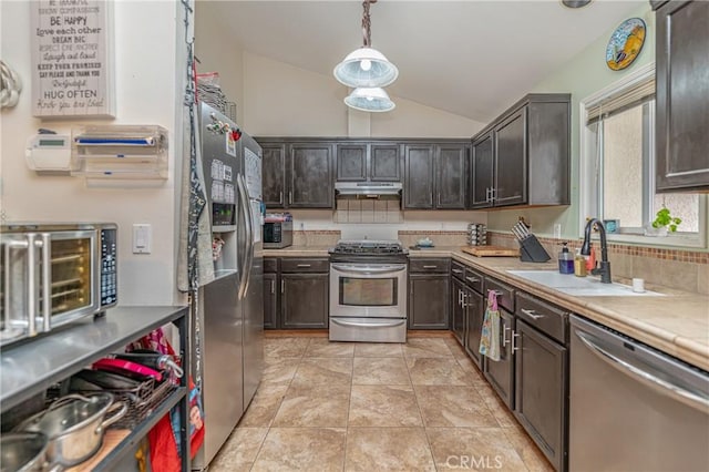 kitchen featuring sink, hanging light fixtures, vaulted ceiling, dark brown cabinets, and appliances with stainless steel finishes