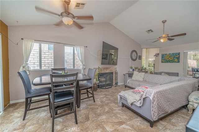 living room featuring ceiling fan and lofted ceiling