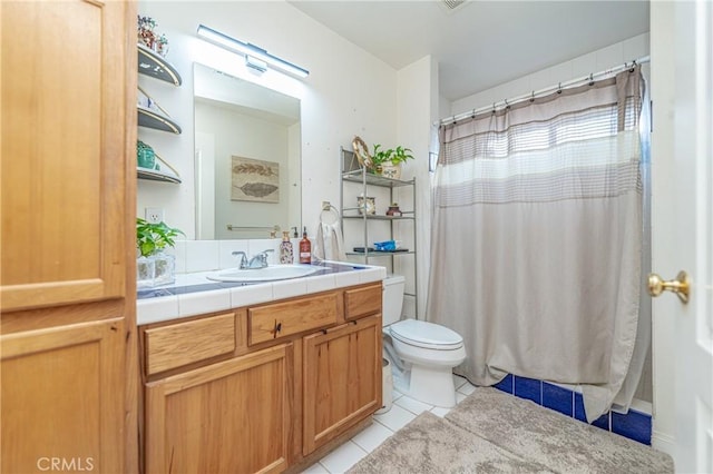 bathroom featuring tile patterned flooring, vanity, and toilet