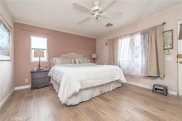 bedroom with hardwood / wood-style flooring, ceiling fan, and crown molding