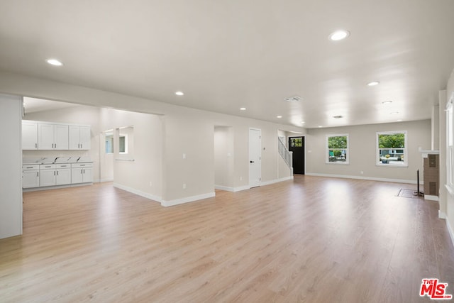 unfurnished living room with light hardwood / wood-style flooring