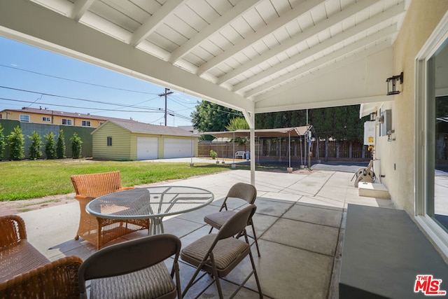 view of patio with a garage and an outdoor structure