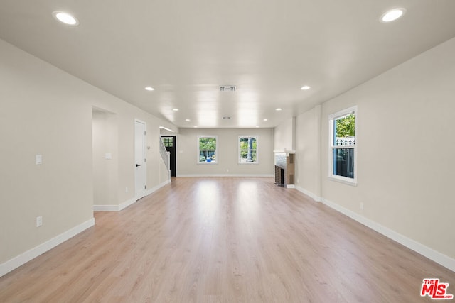 unfurnished living room with light hardwood / wood-style flooring