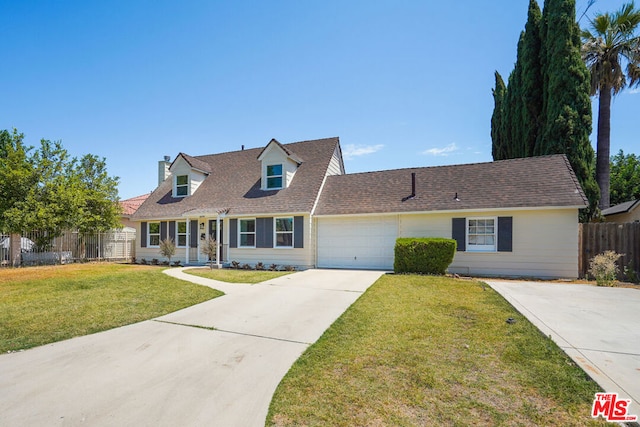 view of front of house with a garage and a front lawn