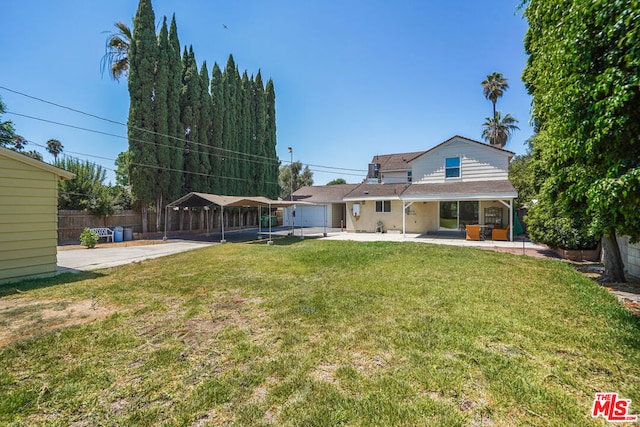 view of yard with a patio area and a carport