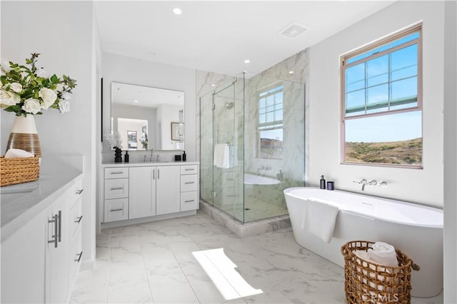 bathroom featuring shower with separate bathtub and vanity