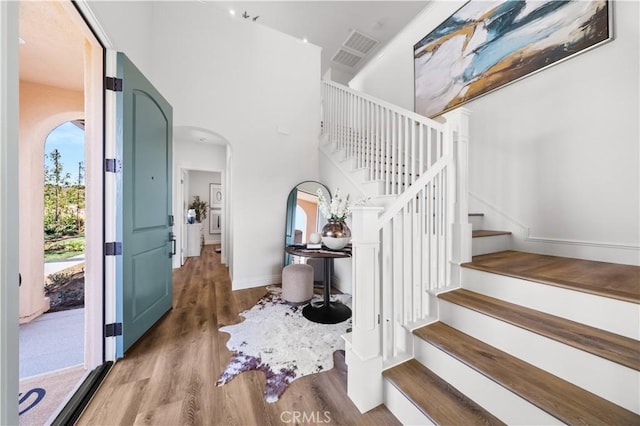 interior space with a high ceiling and hardwood / wood-style flooring