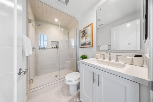 bathroom featuring tile patterned flooring, vanity, toilet, and walk in shower