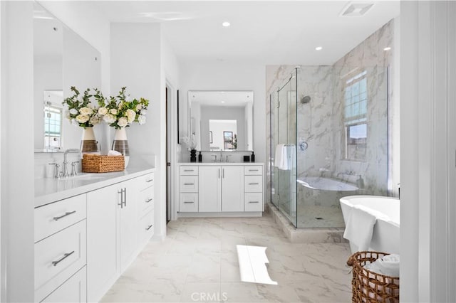 bathroom with vanity, a wealth of natural light, and a shower with shower door