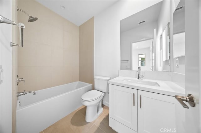 full bathroom with vanity, tile patterned floors, tiled shower / bath combo, and toilet