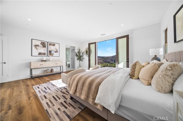 bedroom featuring hardwood / wood-style flooring and access to outside