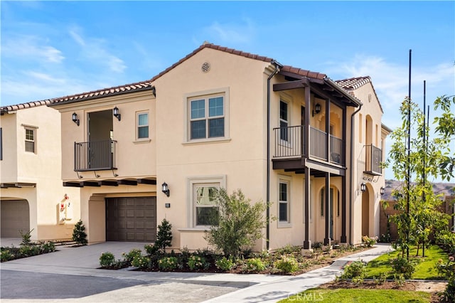 mediterranean / spanish-style home with a balcony and a garage