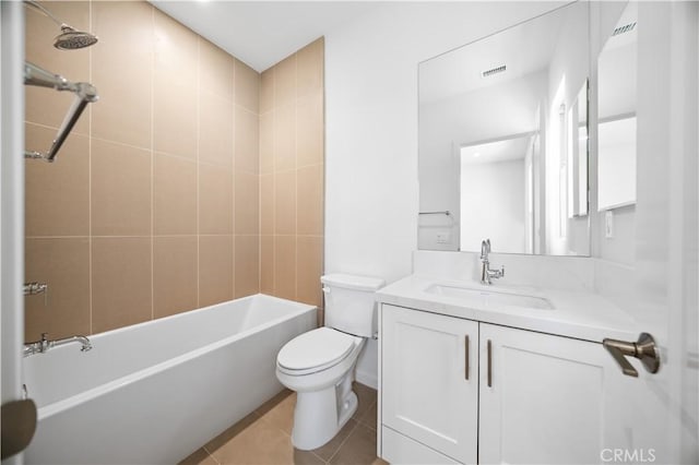 full bathroom featuring tile patterned flooring, vanity, tiled shower / bath combo, and toilet