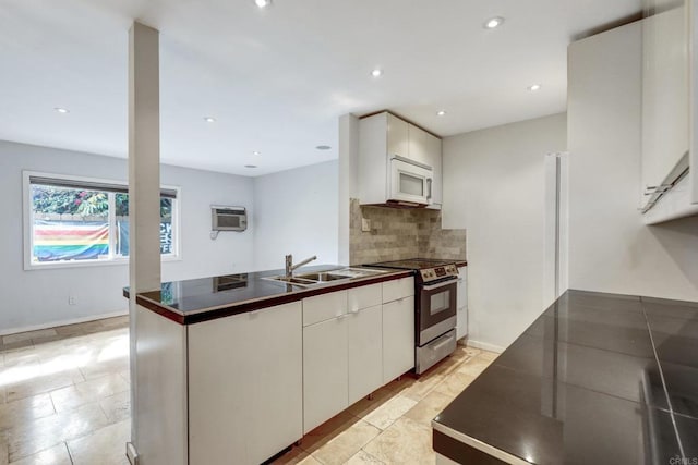 kitchen with white cabinets, a wall mounted AC, tasteful backsplash, and stainless steel electric stove