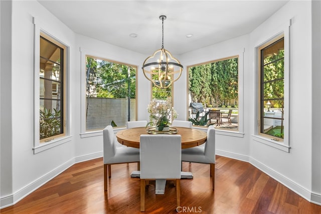 dining space featuring hardwood / wood-style floors and a notable chandelier