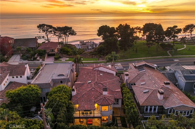 aerial view at dusk with a water view