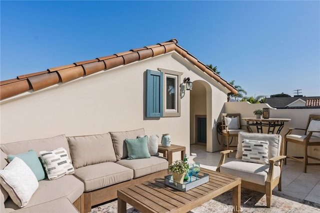 rear view of house with outdoor lounge area and a patio