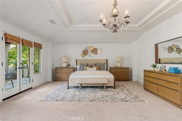 carpeted bedroom with access to outside, a raised ceiling, french doors, and a notable chandelier