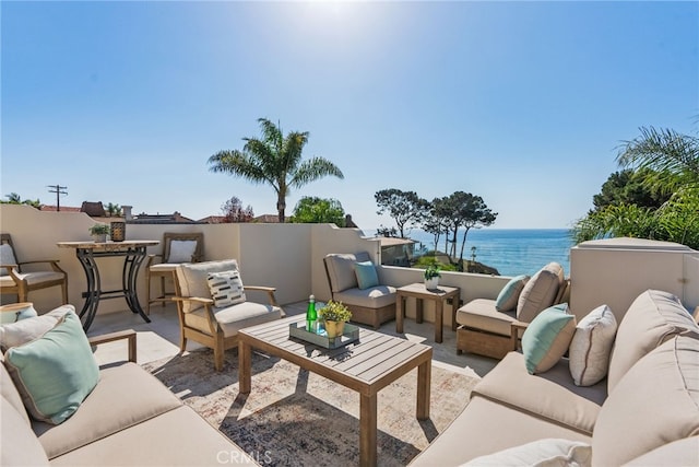 view of patio with an outdoor living space and a water view