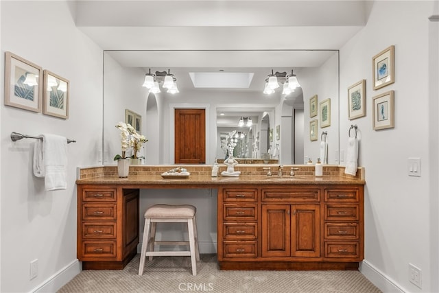 bathroom with vanity and a skylight