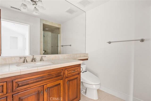 bathroom featuring tile patterned floors, vanity, toilet, and a shower with door