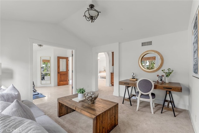 living room featuring light colored carpet and lofted ceiling