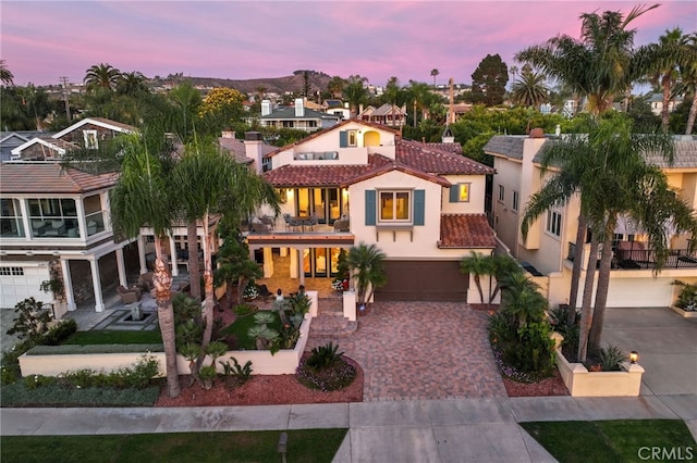 mediterranean / spanish home with a balcony and a garage