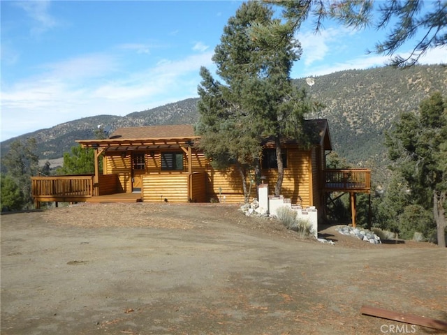 log cabin featuring a deck with mountain view