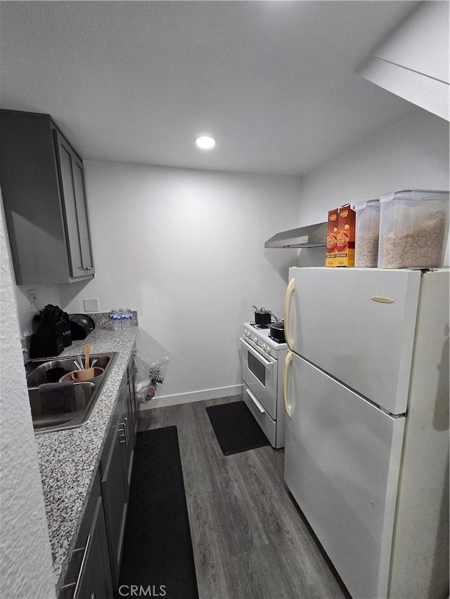 kitchen with white appliances, sink, dark hardwood / wood-style floors, gray cabinets, and light stone counters