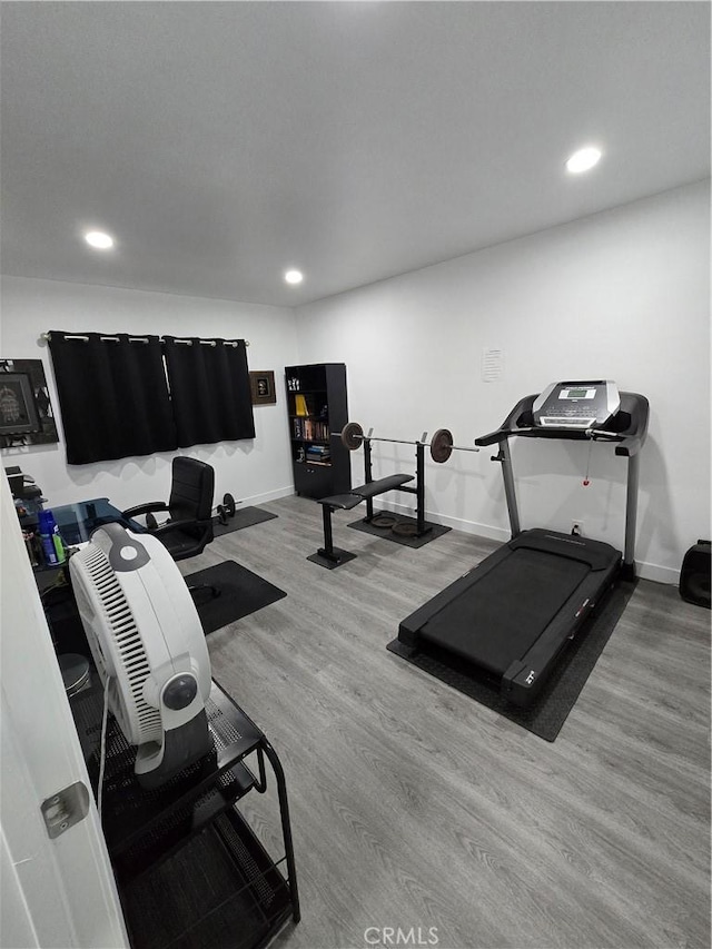 exercise room with hardwood / wood-style flooring