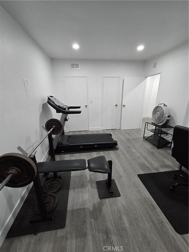 exercise room with hardwood / wood-style flooring