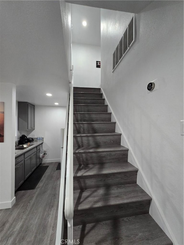 stairway featuring hardwood / wood-style floors