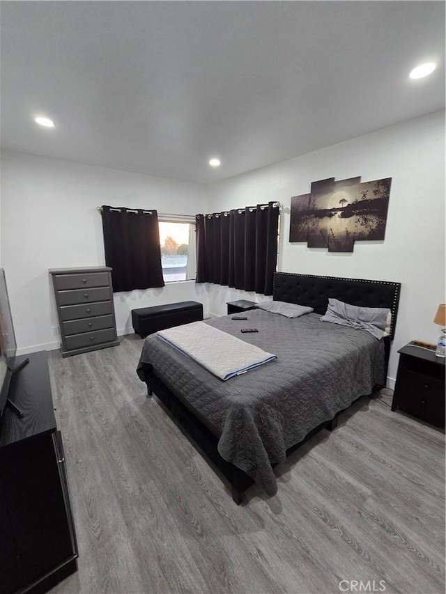 bedroom with hardwood / wood-style flooring