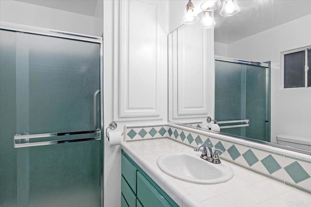 full bath featuring backsplash, a shower with door, vanity, and toilet