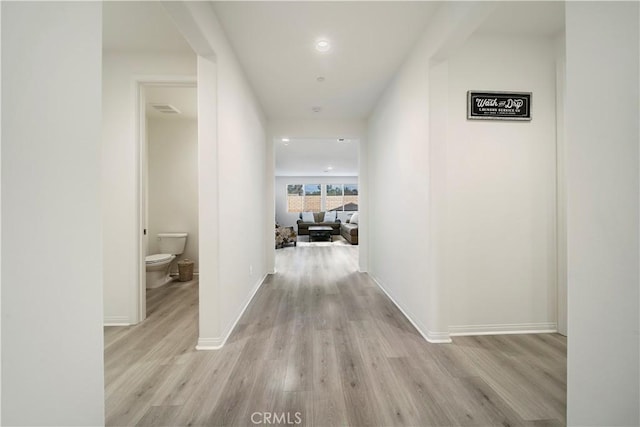 corridor with light hardwood / wood-style flooring