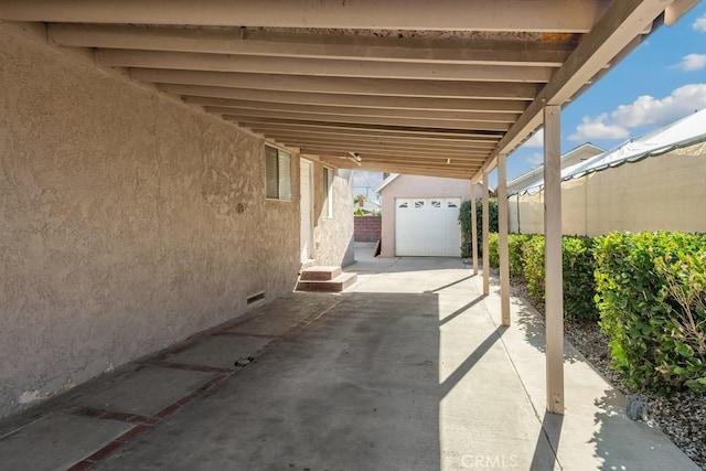 view of patio featuring an outbuilding and a garage