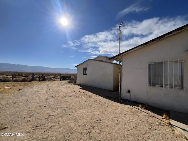 view of side of home with a mountain view