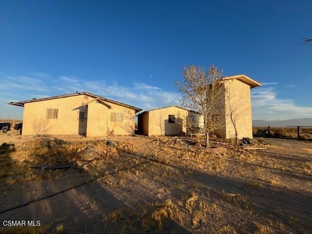 view of side of home with an outdoor structure