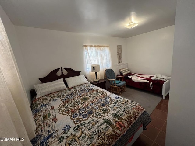 bedroom with dark tile patterned floors