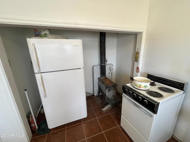 kitchen with dark tile patterned flooring and white appliances